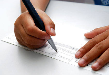 signing check close up with shallow depth of field 