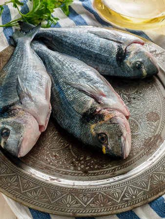 Fresh raw fish and food ingredients on table