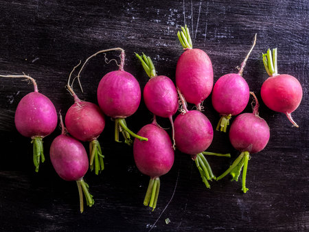 Fresh radishes on a black background