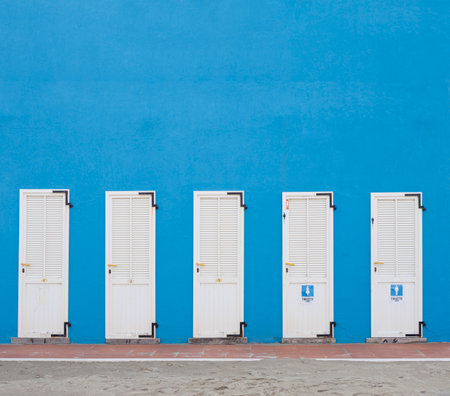 Changing cabins on the beach of a bathhouse with signs on it. Italy, Cesenatico. Empty space on topの写真素材