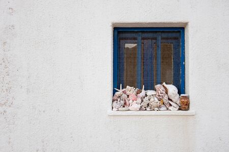 Old window with seashellsの写真素材