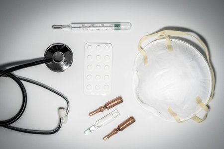 Medical masks with elastic band, thermometer, medicine and stethoscope, Isolated on white background
