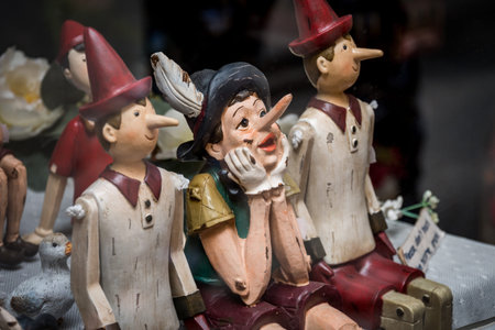 Siena, Italy, April 2018: Wooden statue of Pinocchio with donkey ears and long nose. Pinocchio is the protagonist of a famous Italian fairy taleのeditorial素材