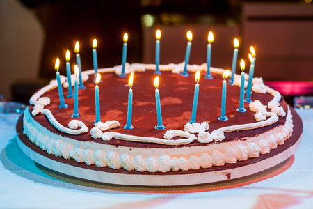 Eighteen years birthday. Chocolate Cake with burning candle.