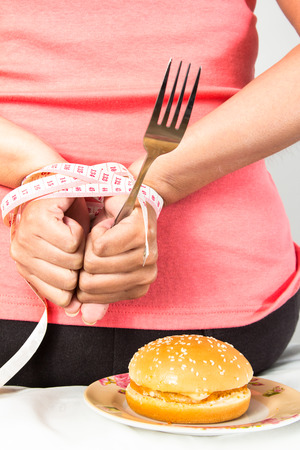 asian woman body with hamburgerの写真素材