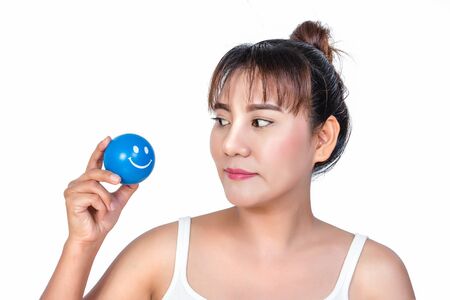 asian woman with smiley face stress ballの写真素材