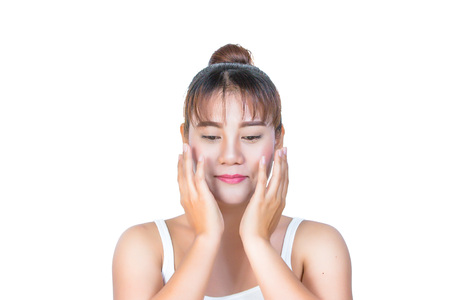 asian woman touching her face on white backgroundの写真素材
