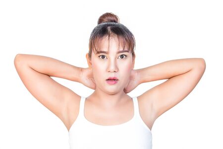woman holding her arms up and showing underarmsの写真素材
