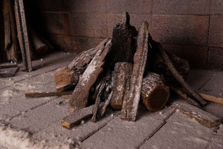 fire pit or barbecue with logs with snow and frozen bricksの写真素材