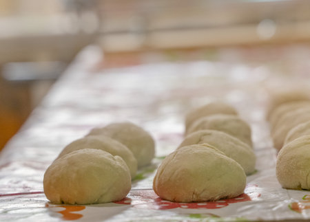 raw balls of bread in the kitchen table