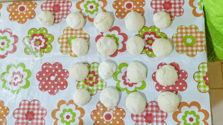 raw balls of bread in the kitchen tableの写真素材