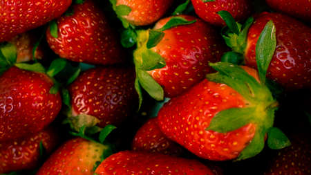 strawberries on a kitchen pot over the wooden tableの写真素材