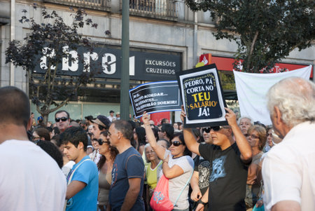 PORTO, PORTUGAL - SEPTEMBER 15: People protesting against government spending cuts and tax rises in Aliados square, Porto on September 15, 2012.のeditorial素材