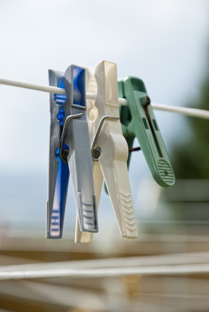 Colorful clothes pegs hanging on the clotheslineの写真素材