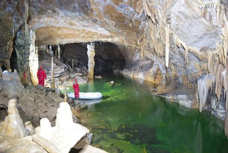 Visitors in the cave at undergoung lakeの写真素材