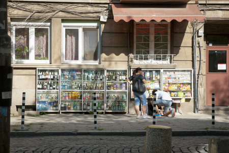 SOFIA, BULGARIA - APRIL 30: People buying groceries in small street shop through the window in Sofia, Bulgaria, on April 30, 2013.のeditorial素材