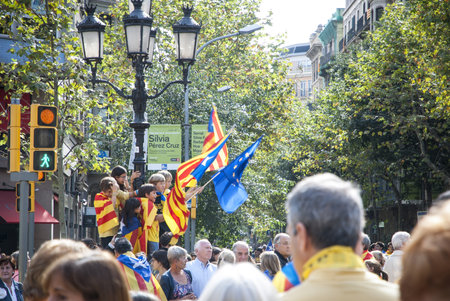 BARCELONA, SPAIN - SEPTEMBER 11: Kids waving with flags during "Catalan Way", silent demonstration for independent Catalonia in Barcelona, Spain on September 11, 2013のeditorial素材