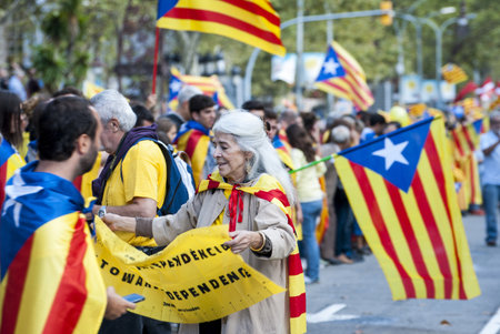BARCELONA, SPAIN - SEPTEMBER 11: People joining the human chain "Catalan Way" crossing all Catalonia, silent demonstration for independent Catalonia in Barcelona, Spain on September 11, 2013のeditorial素材