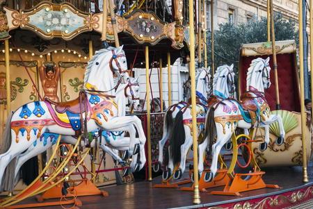 Horses at old fashioned french carouselの写真素材