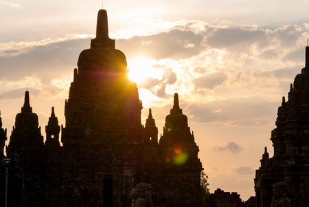 Silhouette of Prambanan temple in sunrise and sun reflection, Yogjakarta, Indonesiaの写真素材