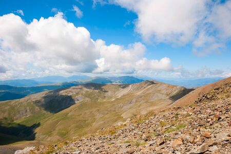 View over green hills and mountains of Pyrenees, Spainの写真素材