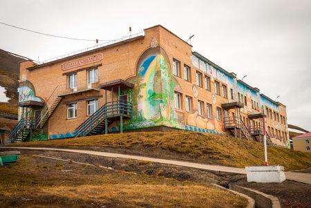 BARENTSBURG, NORWAY - JUNE 21: Colorful painitings with norwegian and russian motifs pained on school facade on Barentsburg school on June 21, 2015のeditorial素材
