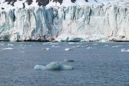 Icebergs in front of the glacier and mountains behind, Svalbard, Norwayの写真素材