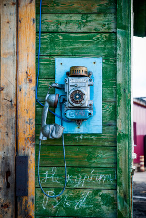 Old fashioned telephone on the wall in Barentsburg city