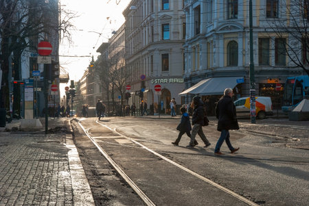 OSLO, NORWAY - JANUARY 29: People crossing tram rails in Oslo downtown in sunny winter day. Taken in Oslo, January 29, 2015.のeditorial素材