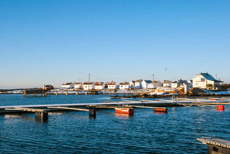 Pier with boats in winter on sunny day, Norway