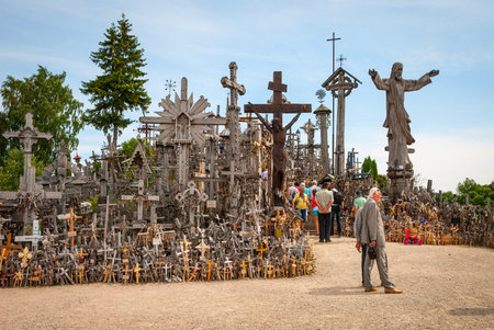 SIAULIAI, LITHUANIA - JULY 18: Pilgrims visiting Hill of crosses (kryziu kalnas) a famous religious...