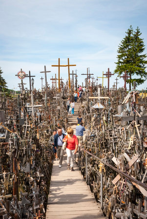 SIAULIAI, LITHUANIA - JULY 18: Pilgrims visiting Hill of crosses (kryziu kalnas) a famous religious landmark in Lithuania on July 18, 2015のeditorial素材