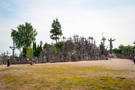 SIAULIAI, LITHUANIA - JULY 18: Pilgrims visiting Hill of crosses (kryziu kalnas) a famous religious landmark in Lithuania on July 18, 2015のeditorial素材