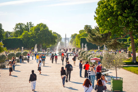 PARIS, FRANCE - JUNE 8: Tourists sitting on chairs near pond of park de Tuileries in Paris, France in june 2015のeditorial素材
