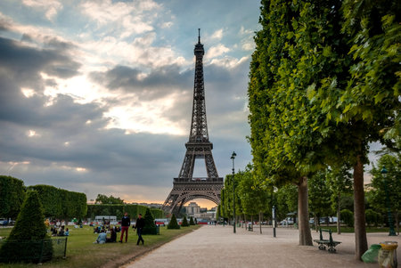 PARIS, FRANCE - JUNE 9: Eiffel tower with park around. Tower was designed by Gustave Eiffel and Stephen Sauvestre in 1889 and is one of main landmark of Paris. June 2015.のeditorial素材