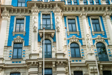 Beautiful decorated building facade with columns in art deco district of Riga, Latviaの写真素材