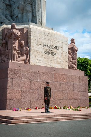 RIGA, LATVIA - JULY 30: Guards standing in front of Freedom monument in Riga. July 2015のeditorial素材