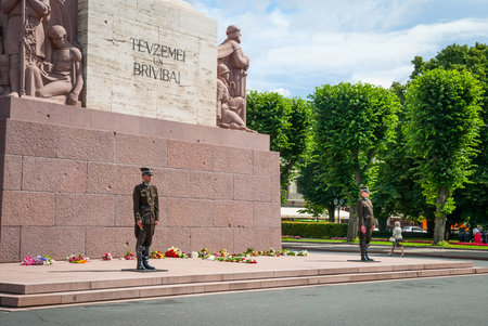 RIGA, LATVIA - JULY 30: Guards standing in front of Freedom monument in Riga. July 2015のeditorial素材