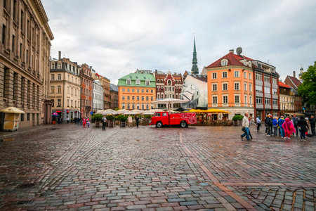 RIGA, LATVIA - JULY 29: View on cobbled pavement of Riga main square and people passing by on coudy day. July 2015のeditorial素材