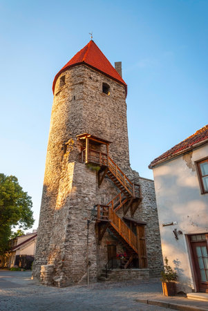 View on ancient street with medieval tower and wall of Tallinn, Estoniaのeditorial素材