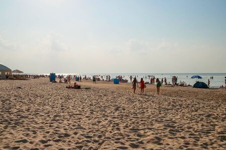 People enjoying sunny summer day on sandy beach in Jurmala.の写真素材