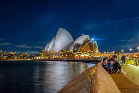 SYDNEY, AUSTRALIA - APRIL 21: Long exposure of people sitting by the Opera bar next to Sydney Opera house in the evening. April 2016.のeditorial素材