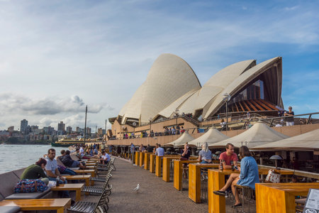 SYDNEY, AUSTRALIA - APRIL 19: People sitting at the Opera bar next to Sydney Opera house. April 2016.のeditorial素材