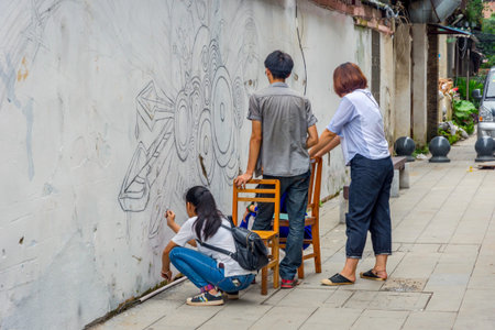 GUILIN CHINA - JUNE 11: Group of young artists painting the wall in Guilin city center Guangxi Zhuang. June 2016のeditorial素材
