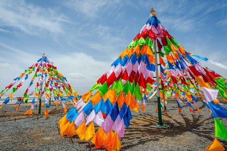 Colorful tibetan buddhist praying flags in the wind next to Chaqia salt lake Qinghai Chinaのeditorial素材