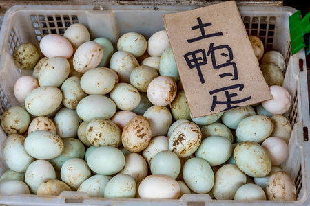 Ducks eggs in a basket at chinese marketの写真素材