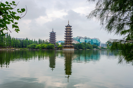 Two towers pagodas of Sun and Moon by the lake. Top tourist attraction in Guilin Chinaの写真素材