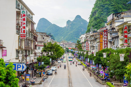 YANGSHUO CHINA - JUNE 12: View over downtown of Yangshuo with recognizable karst peaks in the background. Karst landscape are one of the biggest attractions and landmarks of the area. June 2016のeditorial素材