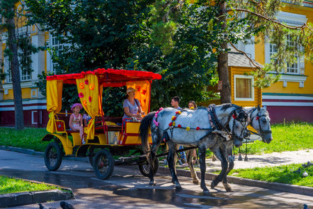 ALMATY, KAZAKHSTAN - JULY 11: Two horse carriage at Imeni, 28 Guardsmen park. July 2016のeditorial素材