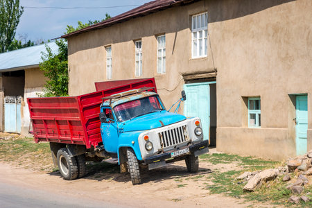 TURBAT, KAZAKHSTAN - JULY 21: Old colorful kazakh truck parked in front of the house. July 2016のeditorial素材